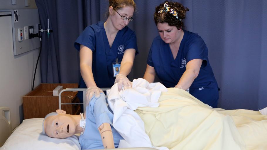 Personal Support Worker students practice on low fidelity mannequin in the Simulation Centre on Waterfront Campus.