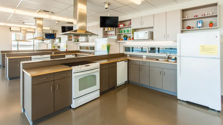 Health eHome Demonstration Kitchens, Simulation Centre, Daphne Cockwell Centre for Health Sciences. Health eHome kitchens. There are 3 kitchens beside one another. Each kitchen has a fridge, stove, TV, microwave, and a sink.