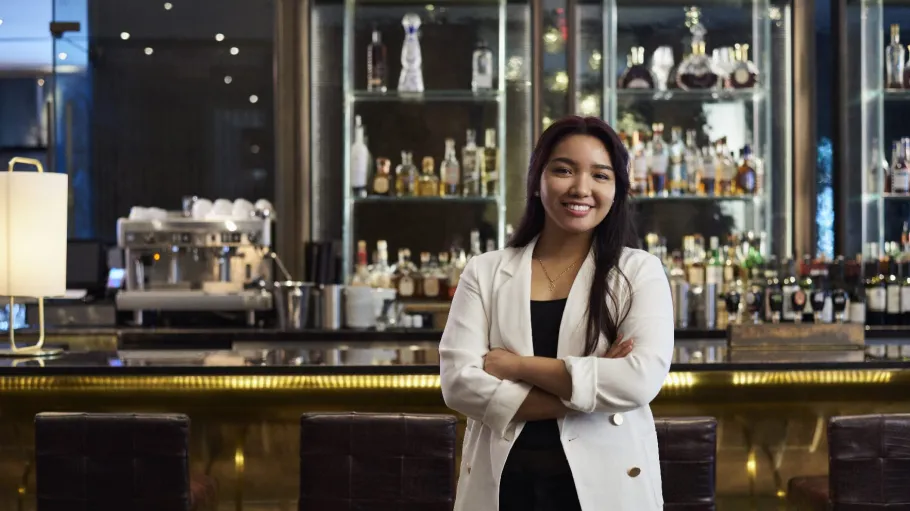 Woman standing in from of bar