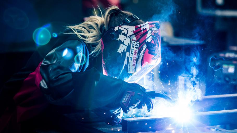 Student welding an object in the lab. 