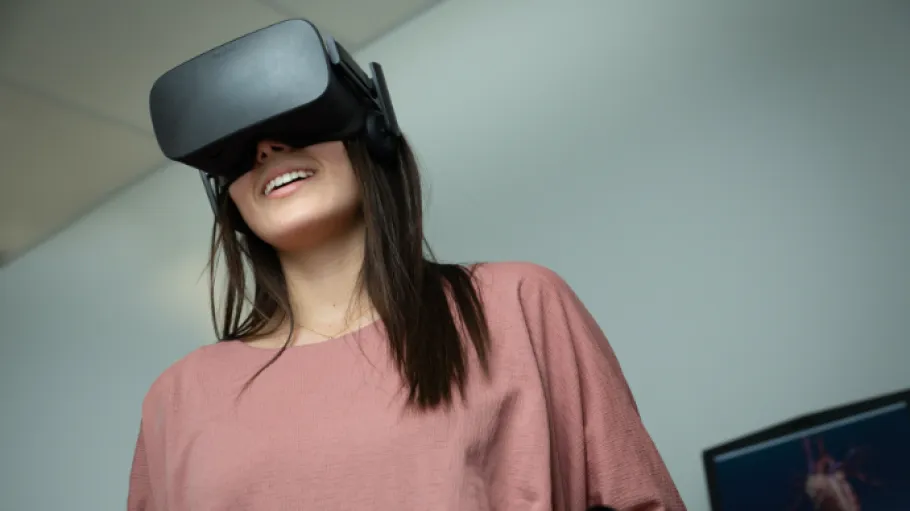 A woman wears a virtual reality headset.