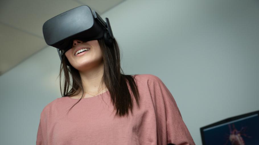 A woman wears a virtual reality headset.