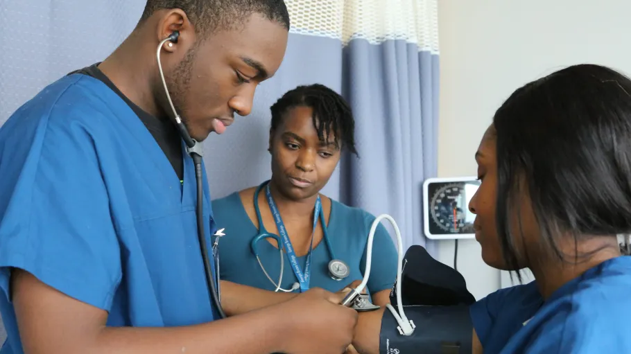 Personal Support Worker student practices on another student while another student observes in the Simulation Centre on Waterfront Campus.
