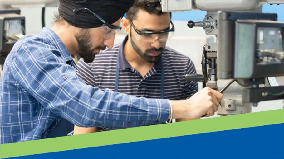 Mechanical Engineering students work on a machine.