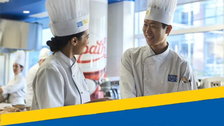 Culinary students cut dough in a Baking Lab.