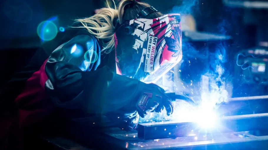 Student welding an object in the lab. 