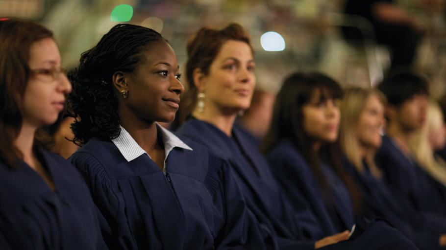 A close-up of seated female graduates during a convocation ceremony. Keywords