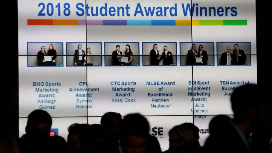 Big screen showing 2018 5 to Watch student award winners