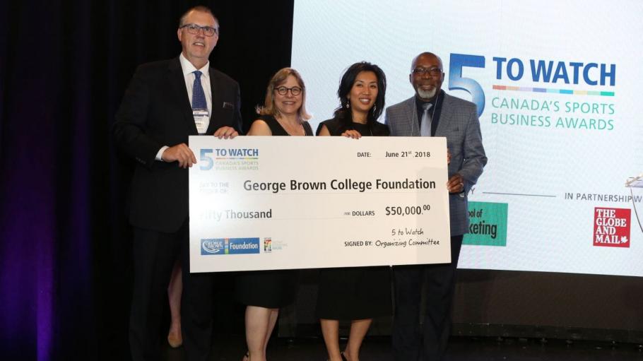 Representatives from George Brown College Foundation on stage with a large cheque