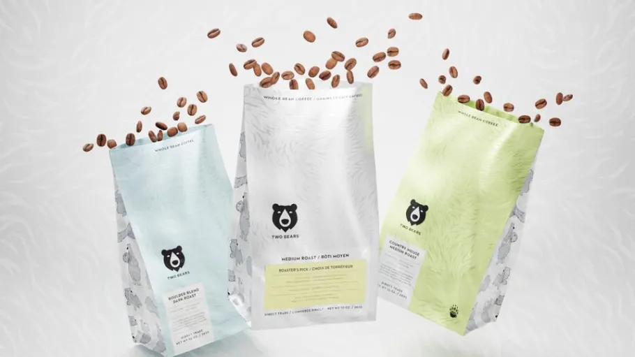 3 bags of coffee with beans coming out of the top