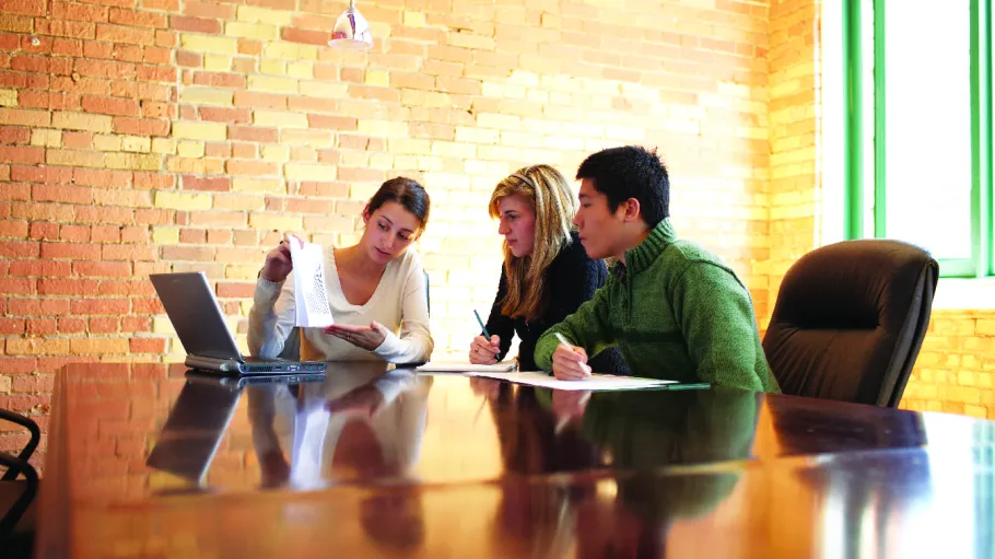 Business students in a meeting in the workplace.
