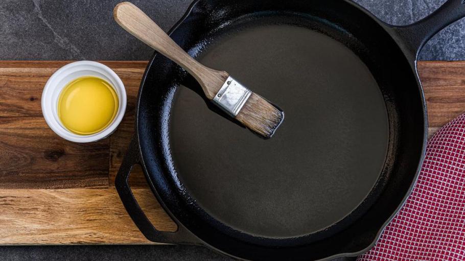 Ramekin of oil and black cast iron pan