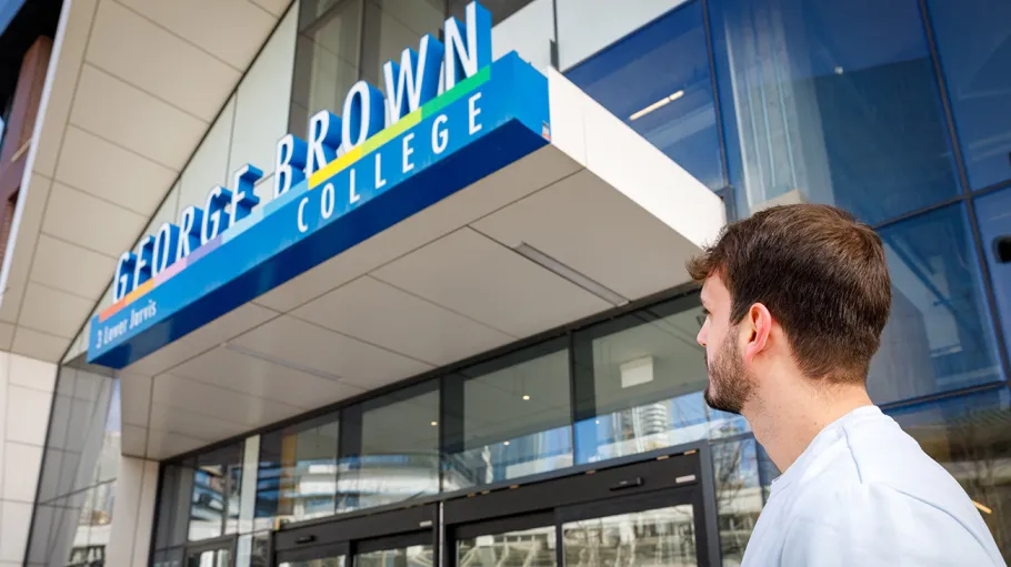 Student looking up at GBP sign