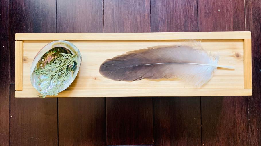 The ceremonial Eagle Feather rests on a wooden case.