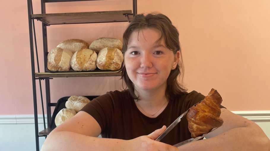 Jillian Lassaline holding croissant at her bakery