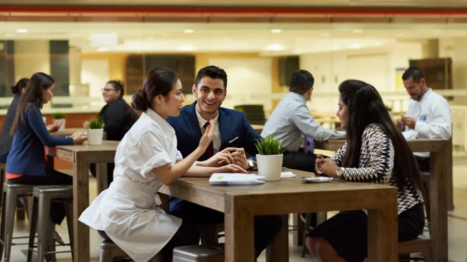 A photo of a CHCA Ambassador speaking to two individuals