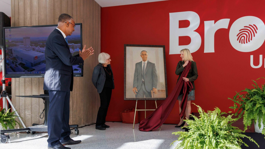 Former Brock University President Gervan Fearon (left) watches an unveiling of his portrait by artist Jane Dywan (centre) and Interim President and Vice-Chancellor Lynn Wells at the Rankin Family Pavilion on Friday, Sept. 23.