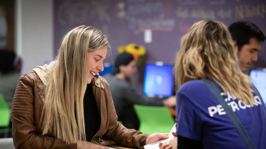 student with a peer coach at a table