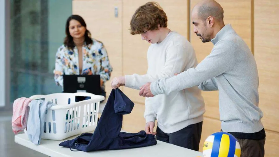 Behavioural Science Technician student working with a client with an instructor looking on.