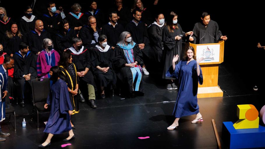 Graduate walking across the Convocation stage