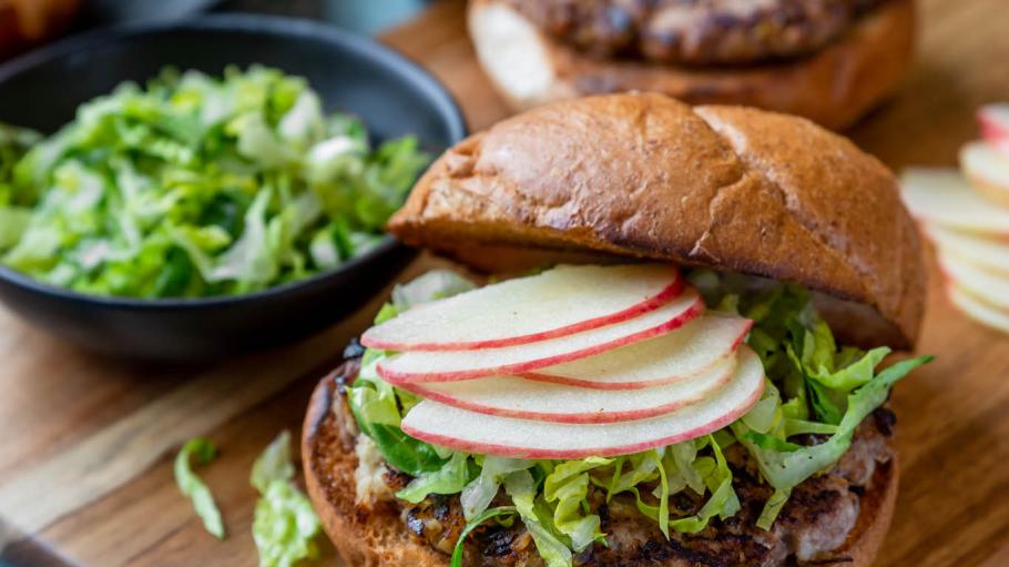 A burger adorned with bright veggie toppings