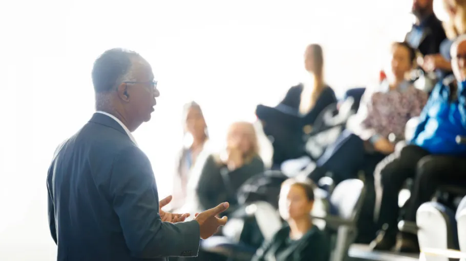 Dr. Gervan Fearon speaking to a crowd at a college event