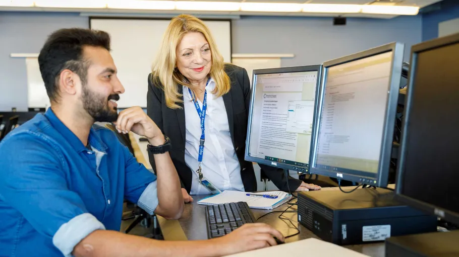 Man and woman starting at a computer screen