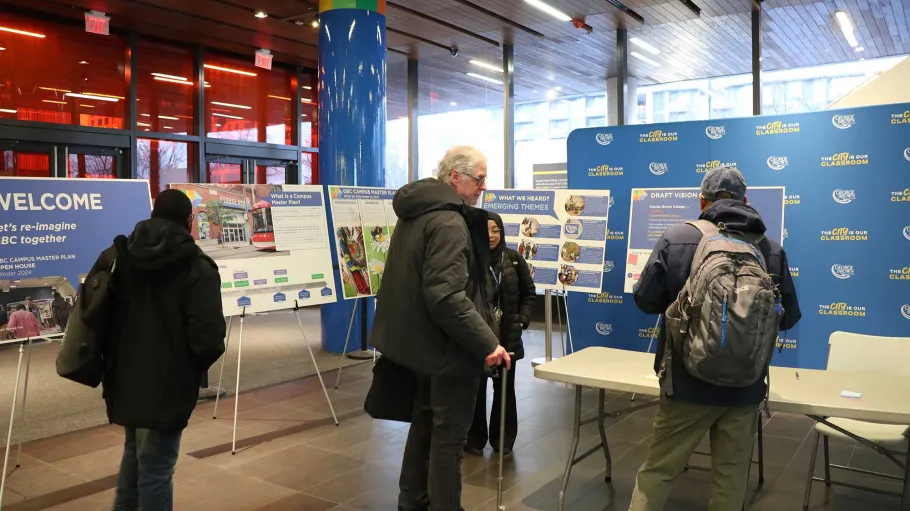 Visitors looking at a Campus Master Plan display
