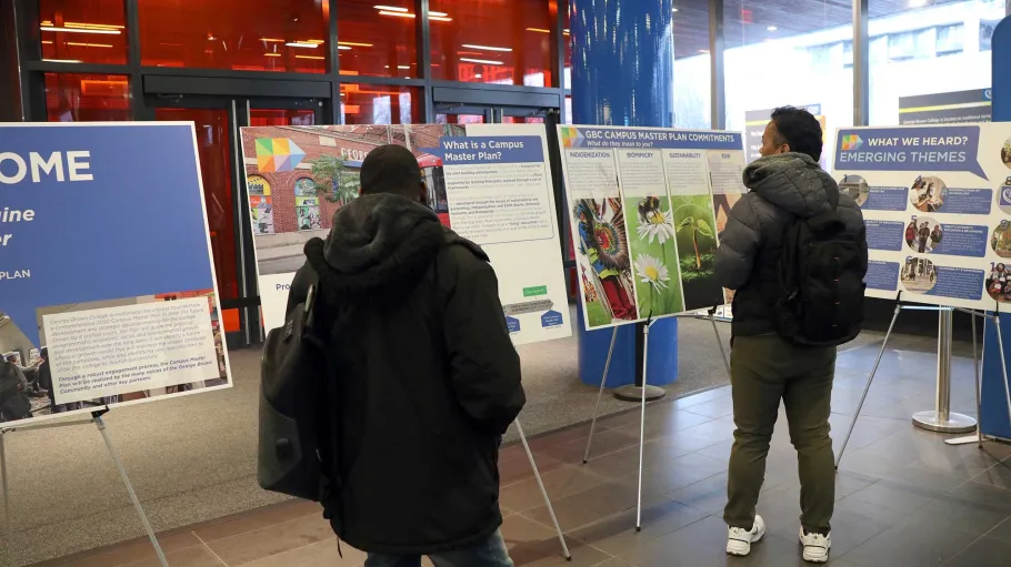 Visitors looking at Campus Master Plan display