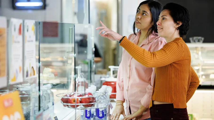 2 students looking at options in the food court 