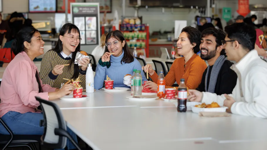 Group of students eating at a food court table