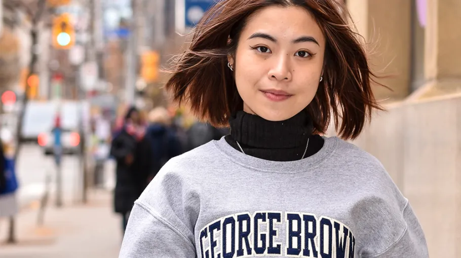 Student wearing GBC sweater outside 200 King Street East