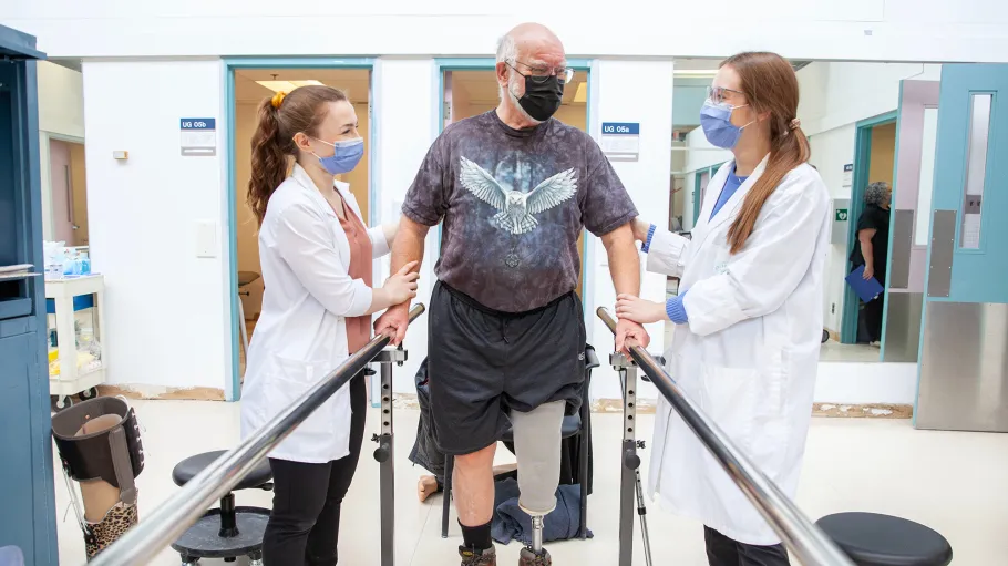 2 students working with a client at Sunnybrook hospital