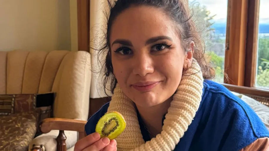 GBC student holding a slice of kiwi
