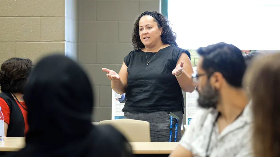 Dr. Krista Holmes speaking to participants at the EvolvED conference, 2023