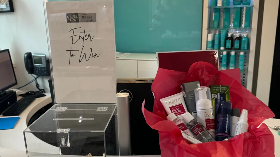 A raffle prize set up including a basket of beauty products.