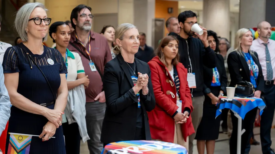 A group listens to the opening remarks at the Pride kick-off event