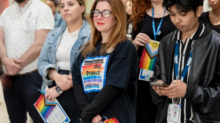 A group listens to Pride kick-off event the opening remarks