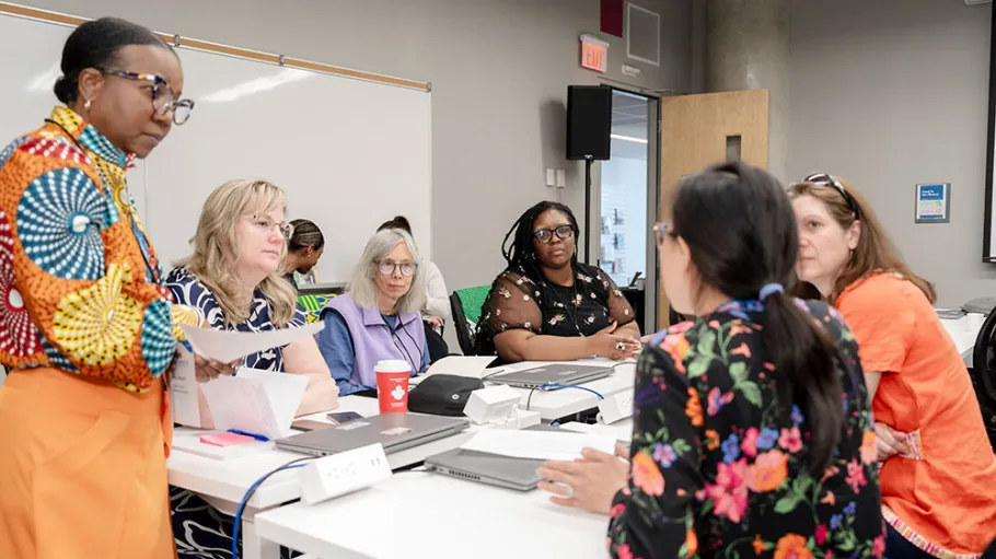 Faculty member Carla Moore checking in on workshop group