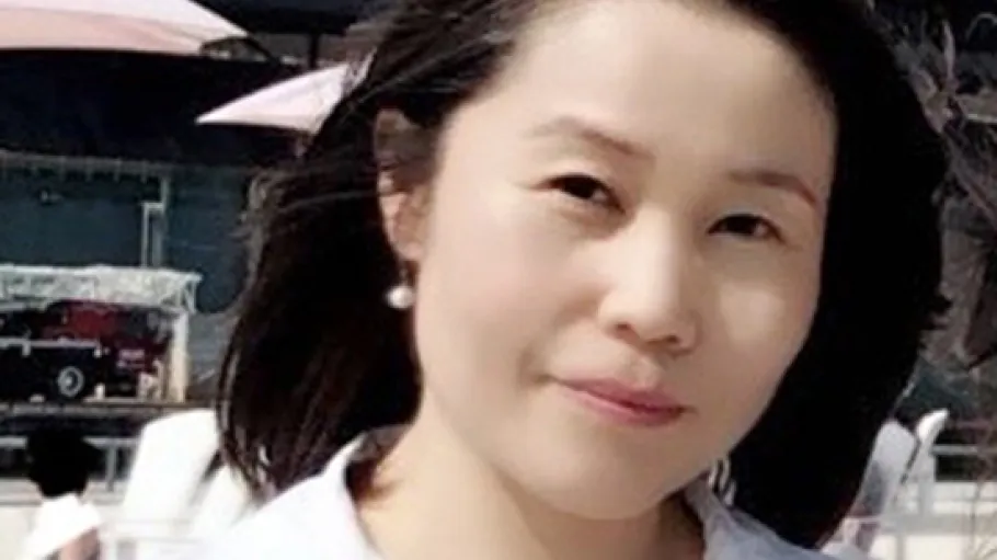 A woman with black hair and a white shirt