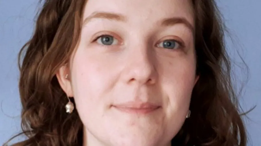 A woman with brown hair and a black shirt