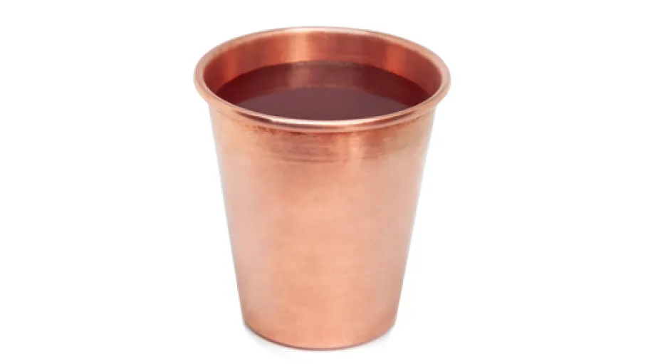 Copper cup with water isolated on white background