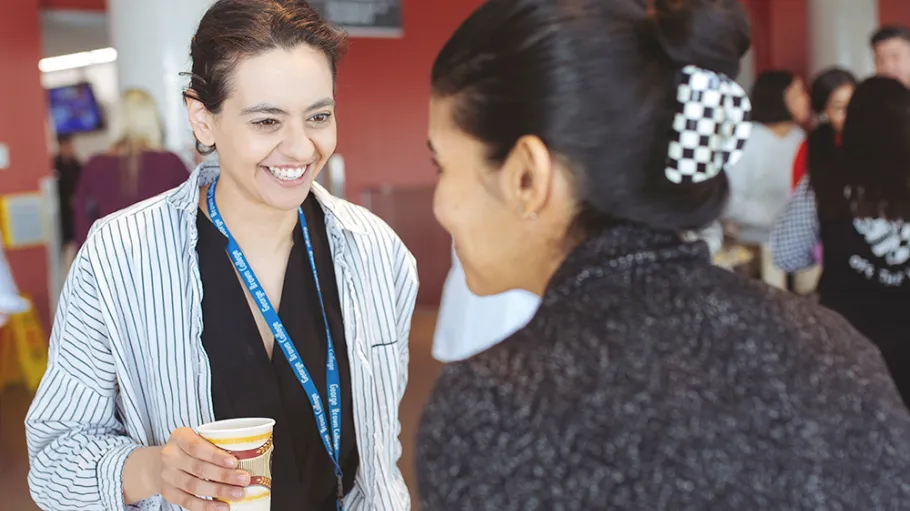 2 employees chatting over coffee