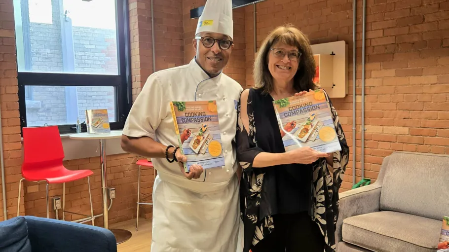 Chef Warren Ford and Professor Linda Gillis holding their cookbook