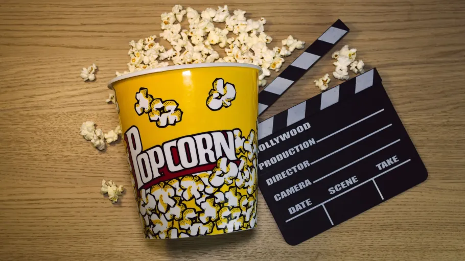 a bucket of popcorn and clacker board