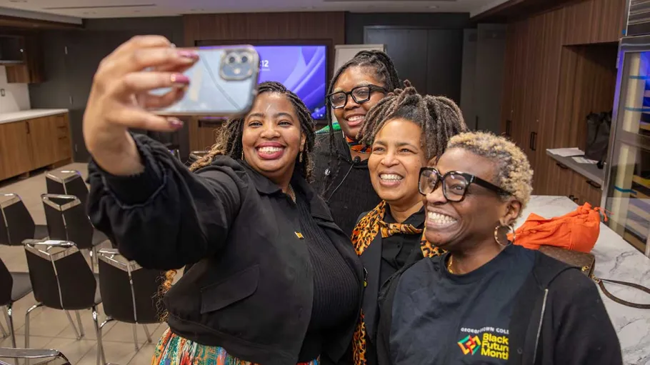 4 employees taking a selfie