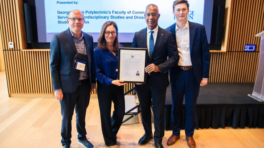 Leadership pose with a Minister's assistant and a certificate at the Mental Health Conference