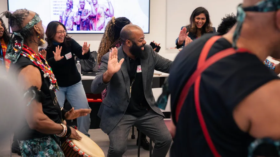 Participants at the Mental Health Conference engage in a drumming activity