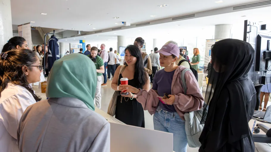 Research Innovation Showcase with guests engaging with projects on display