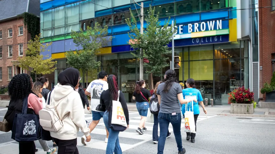 A tour group walks across Adelaide Street to the SJB building.